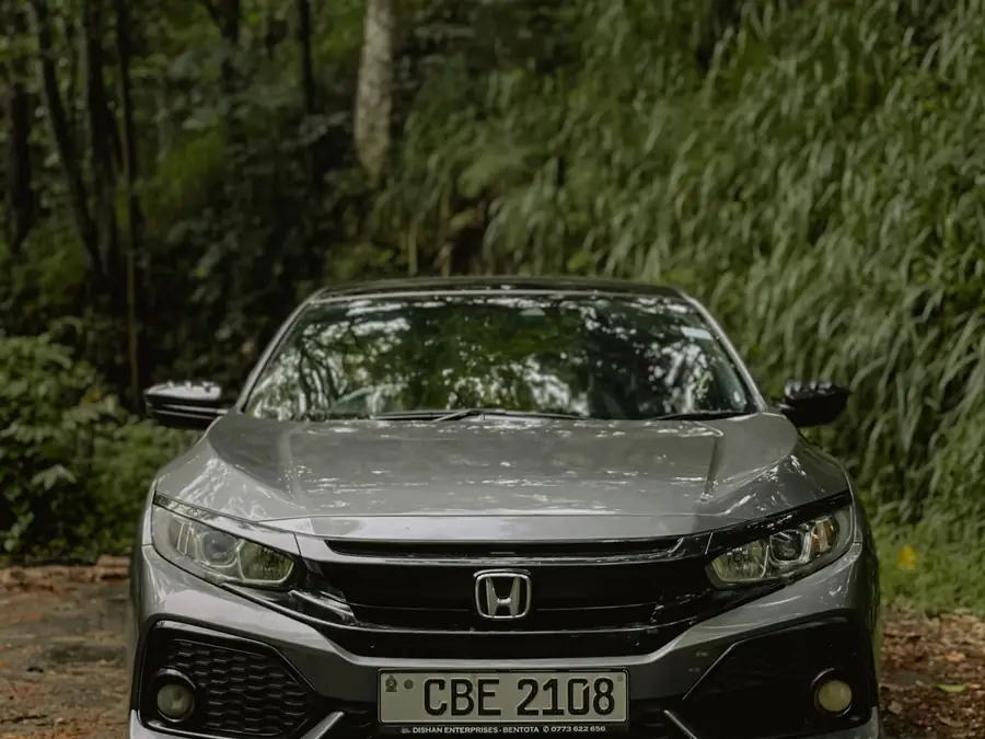 Grey Honda Civic 1.5 TC-P photographed head-on against a wooded background