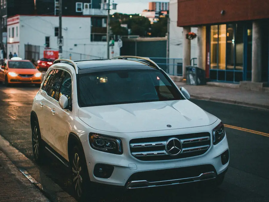 White Mercedes-Benz GLC 200 waiting at a city junction at dusk