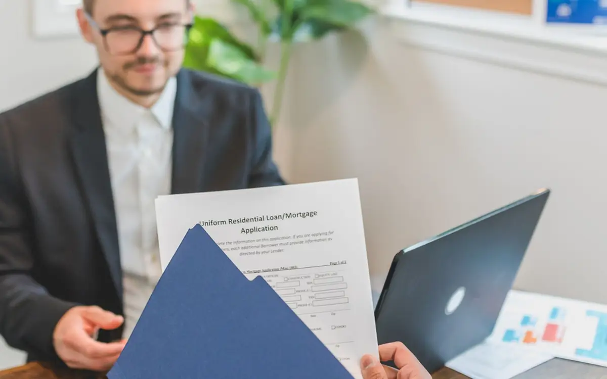 A finance officer going through a vehicle loan application at the desk